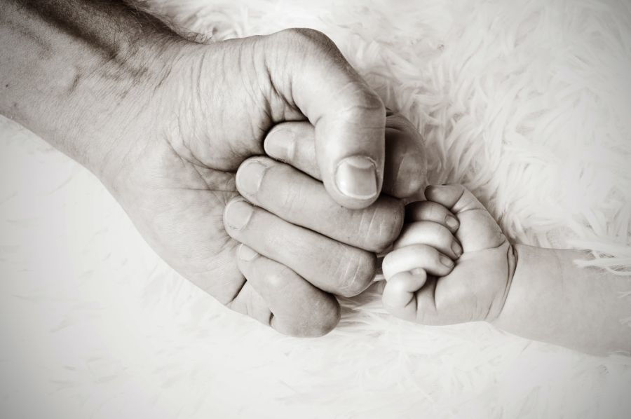 A man and a baby's hands