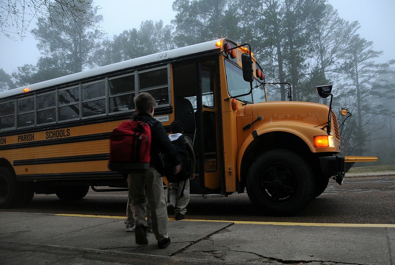 children going on a school bus