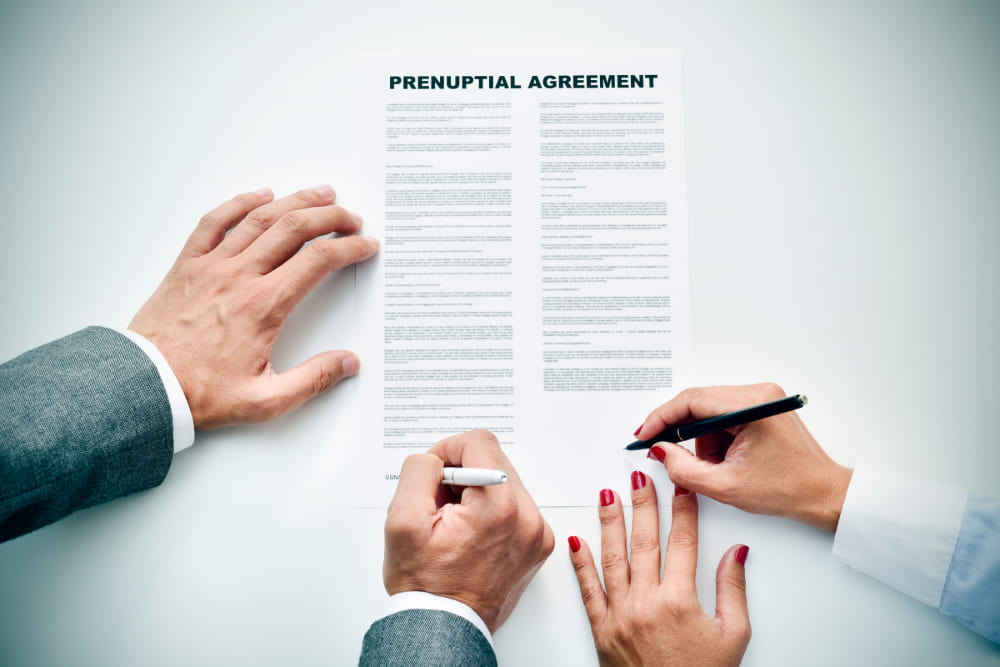 Couple signing a prenuptial agreement